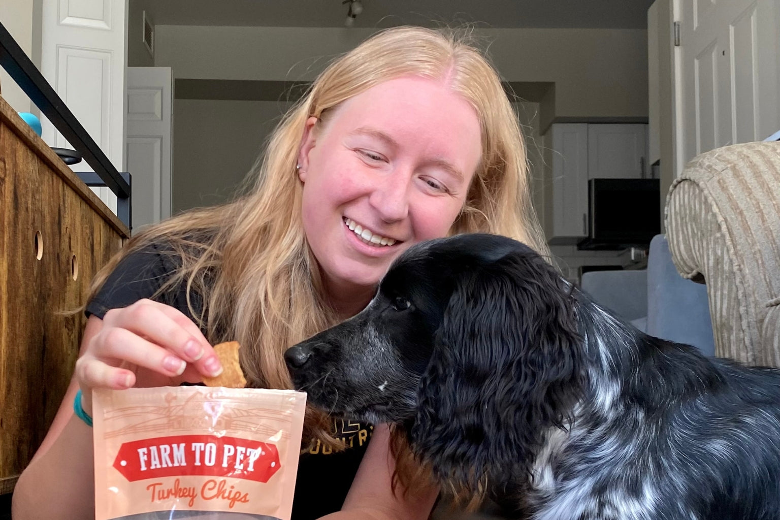 Dog waiting to be fed Farm to Pet Turkey Chips from his owner, Sarah.