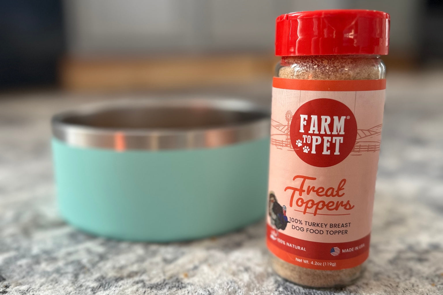 Farm to Pet Turkey Treat Topper next to a bowl of kibble.