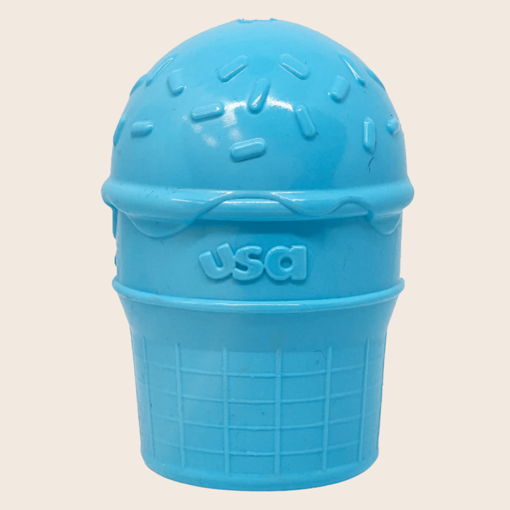 Farm to Pet Dog Treat Dispensers blue ice cream container with 'USA' text on a beige background.
