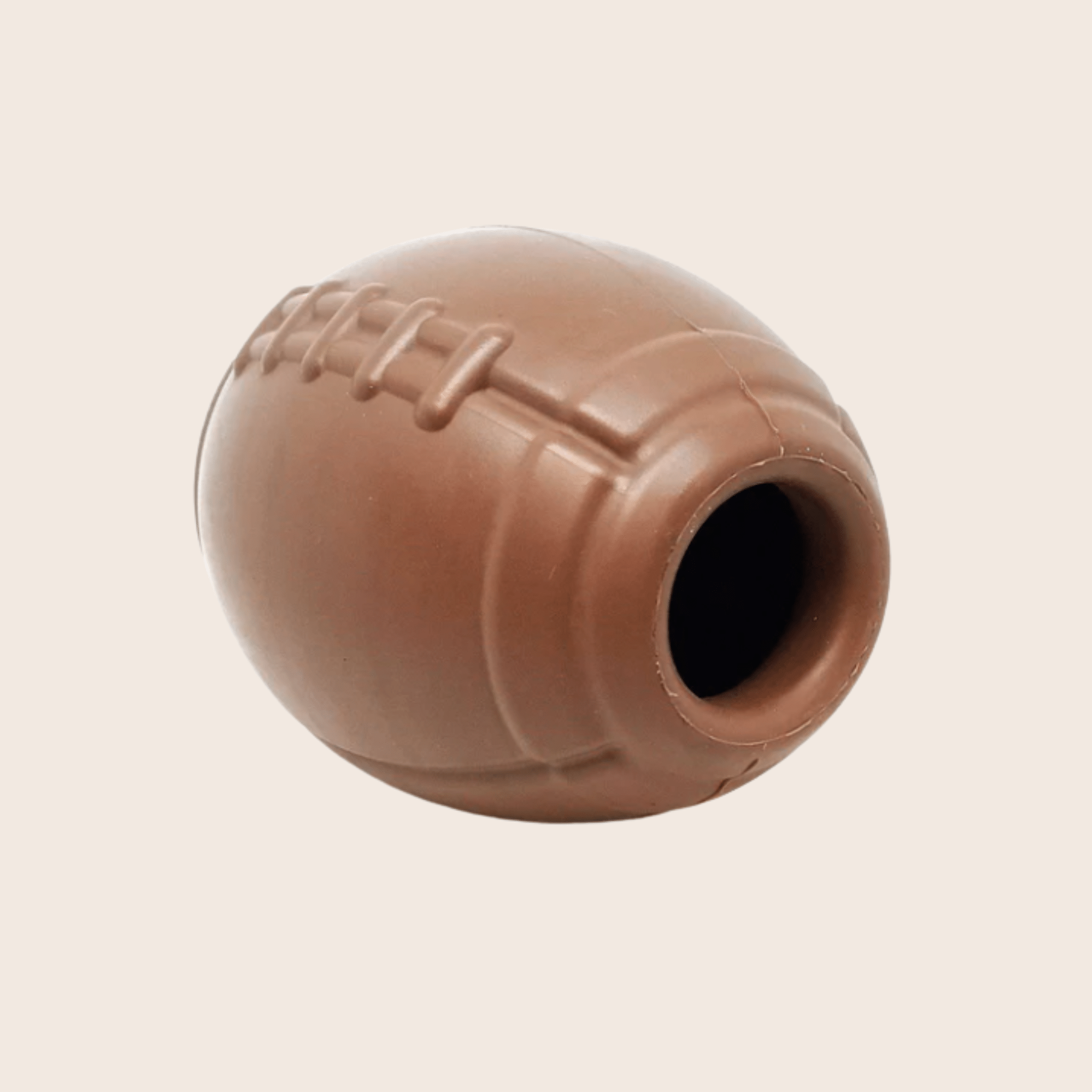 Farm to Pet Dog Treat Dispenser Brown football side view on a beige background
