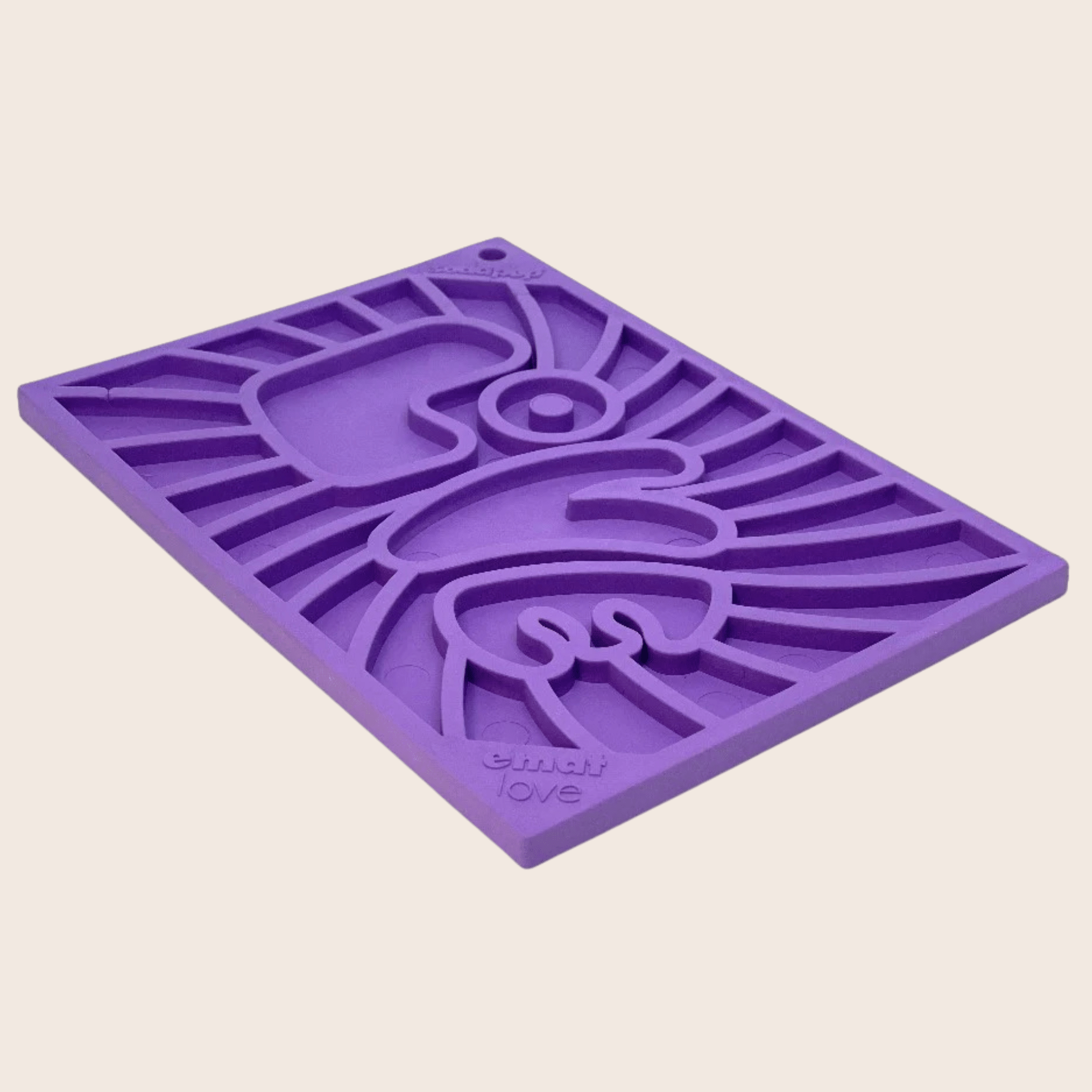 A sideview of a Farm to Pet Purple Groovy Lick Mat with the word LOVE on a beige background.
