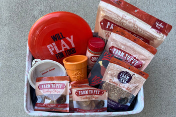 basket of various Farm to Pet treats and dog toys