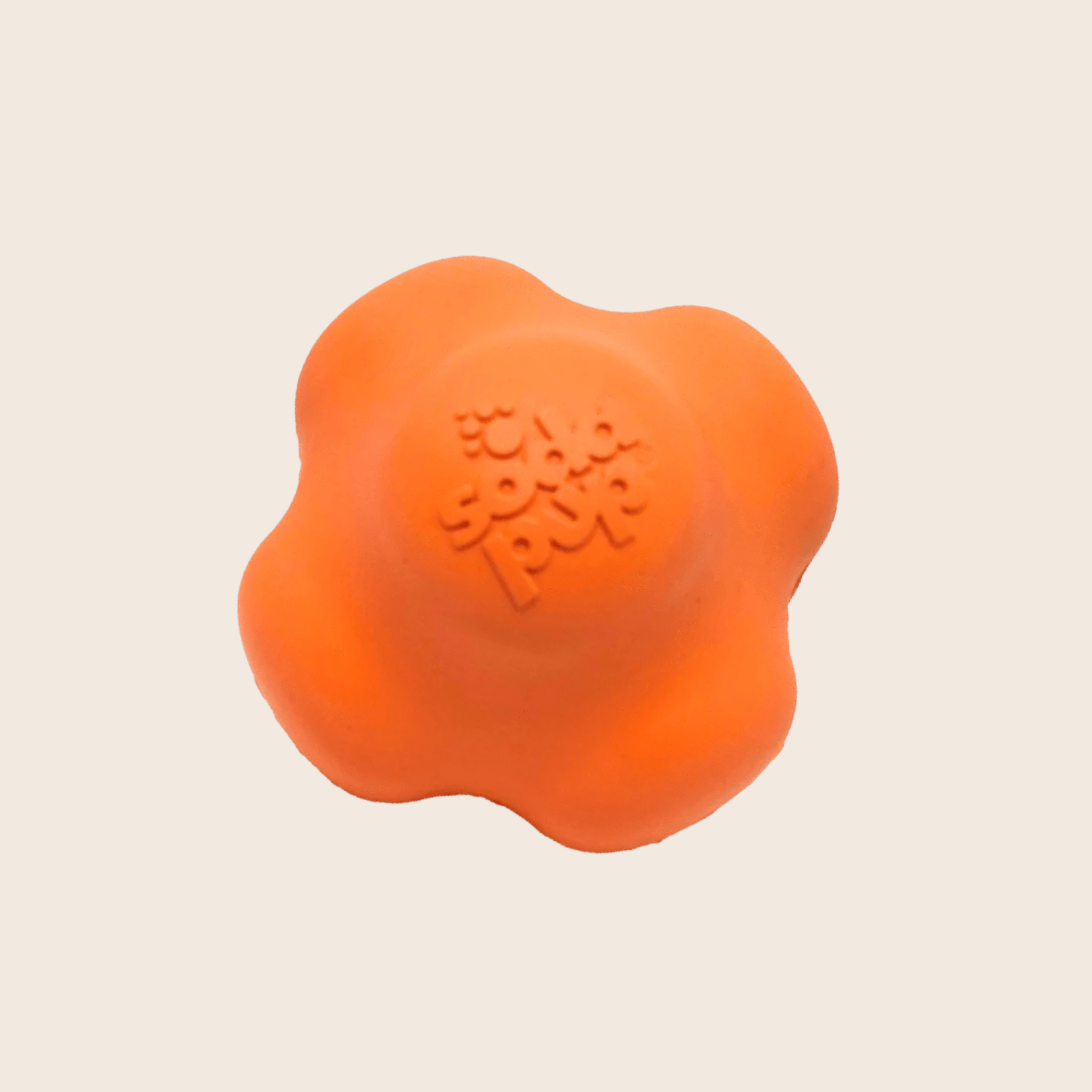 A Farm to Pet Dog Fetch Ball Orange Crazy Bounce Ball a dog toy on a beige background