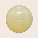A Farm to Pet Dog Fetch Ball Glow-in the Dark Squeak ball is Round, white colored on a light beige background.