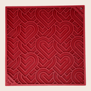 Farm to Pet Red Heart lick mat  textured square with heart patterns on a beige background.