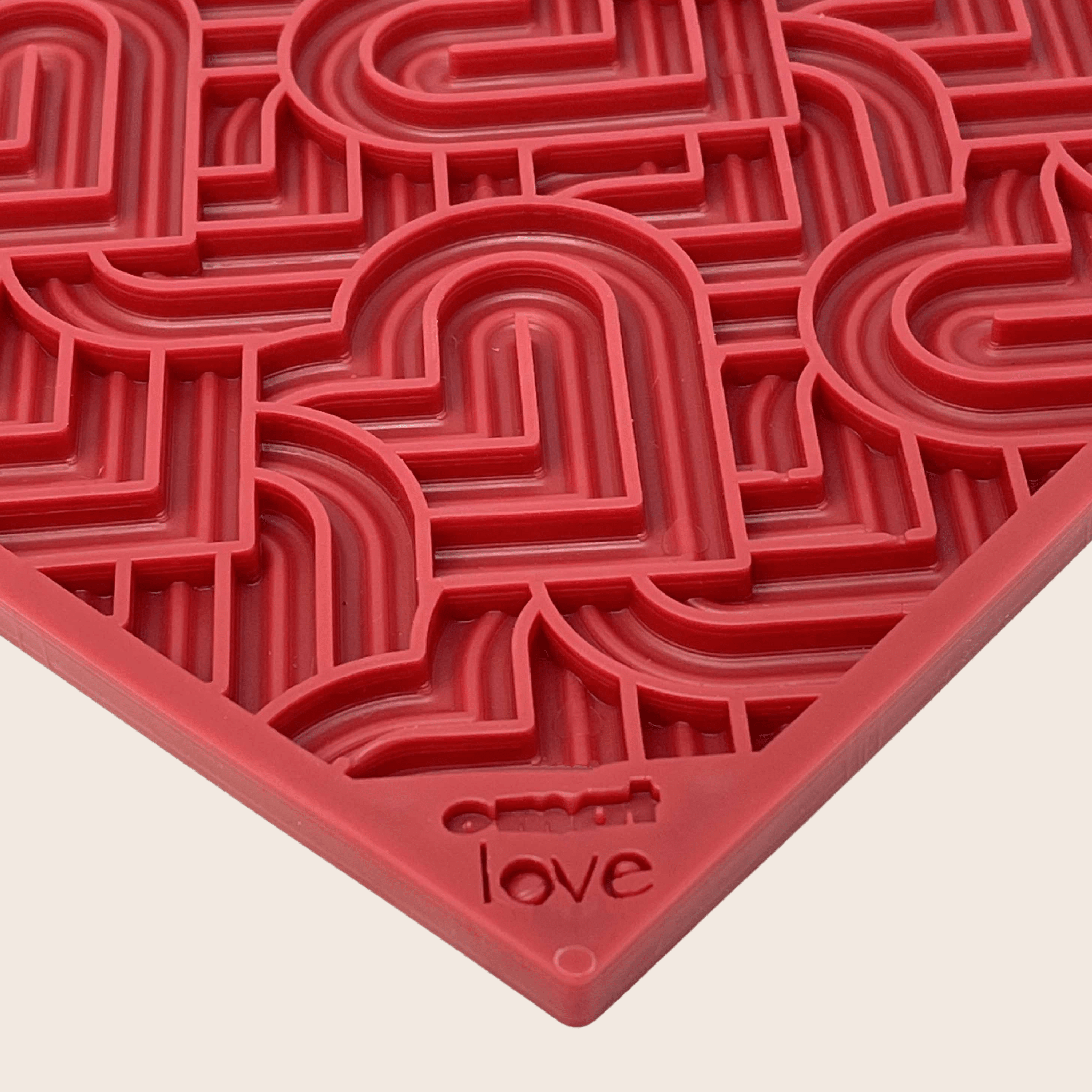 Farm to Pet Red Heart lick mat  with 'love' engraved on a beige background.