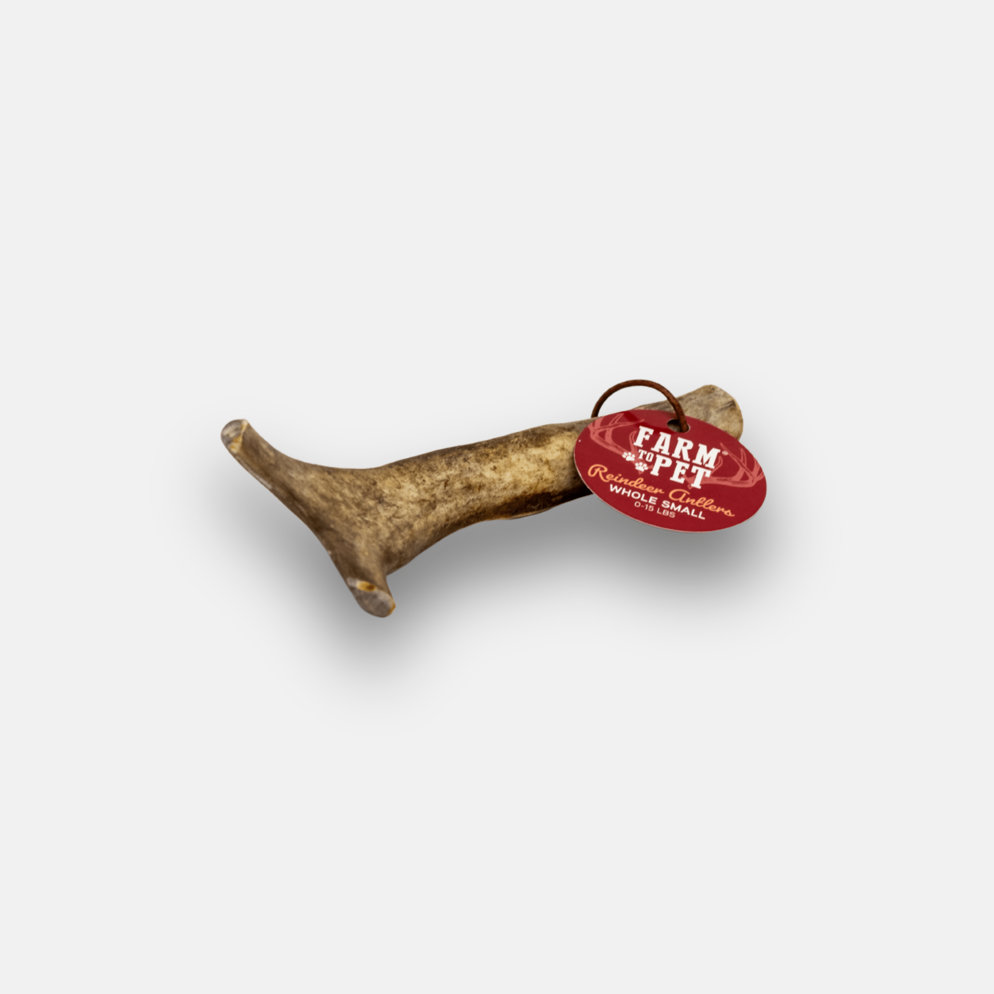 Farm to Pet reindeer antler with a red and white label on a white background.