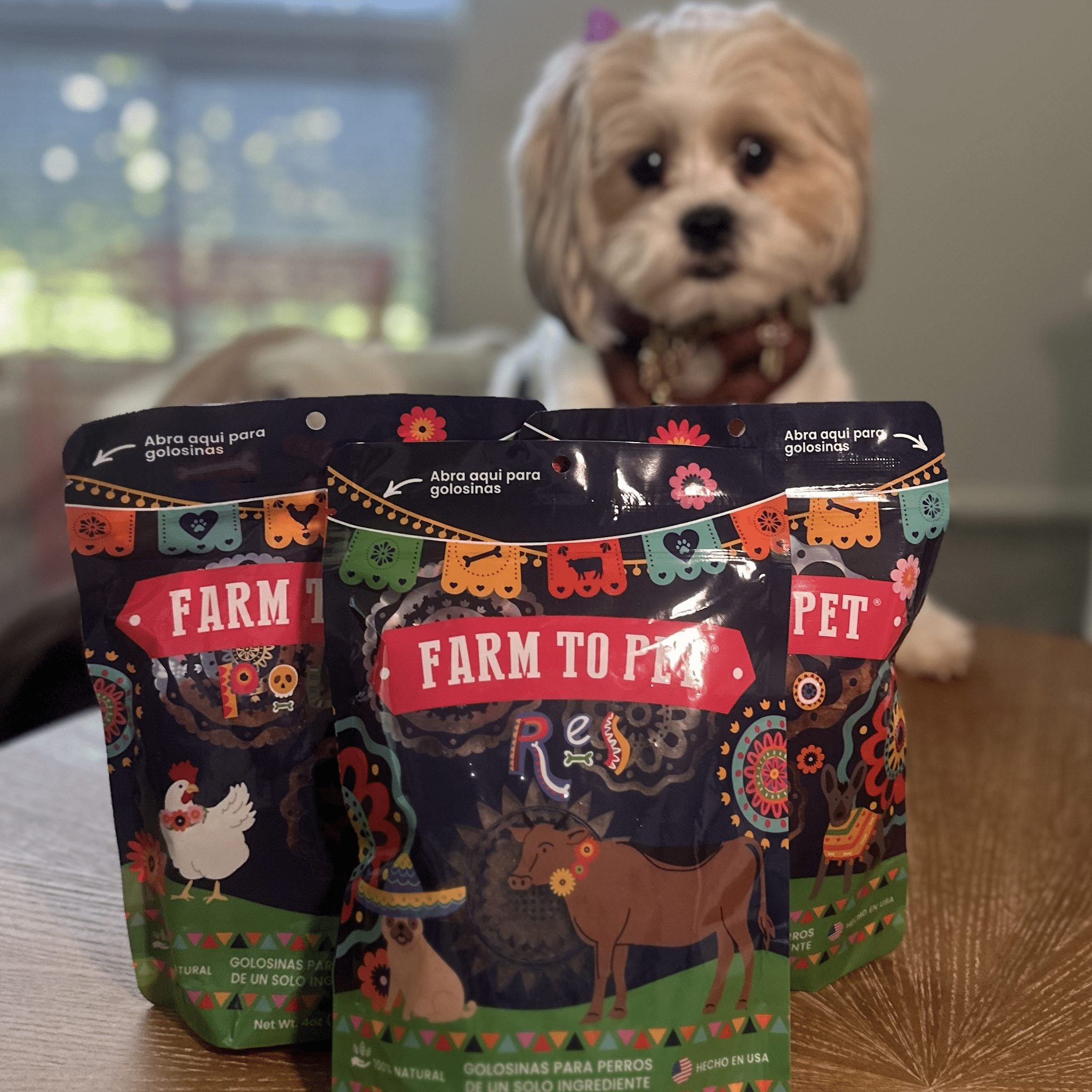 Three colorful packages of Farm to Pet pet food with a dog in the background.