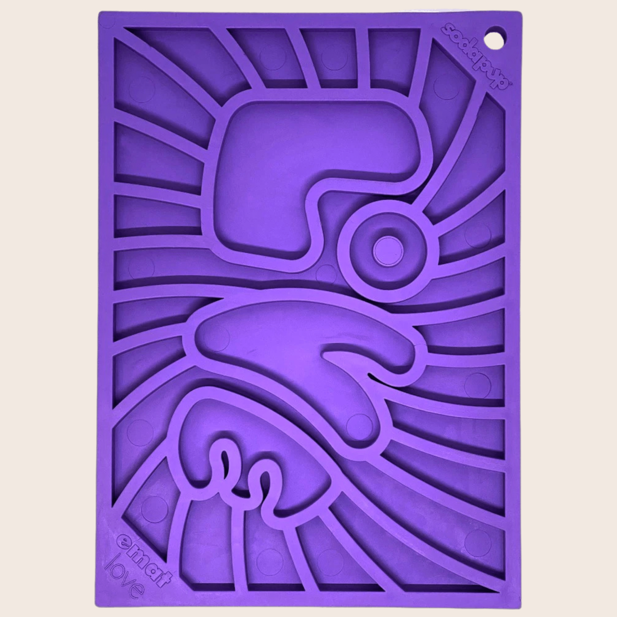 A Purple Groovy Farm to Pet lick mat with geometric design the word LOVE on a beige background.