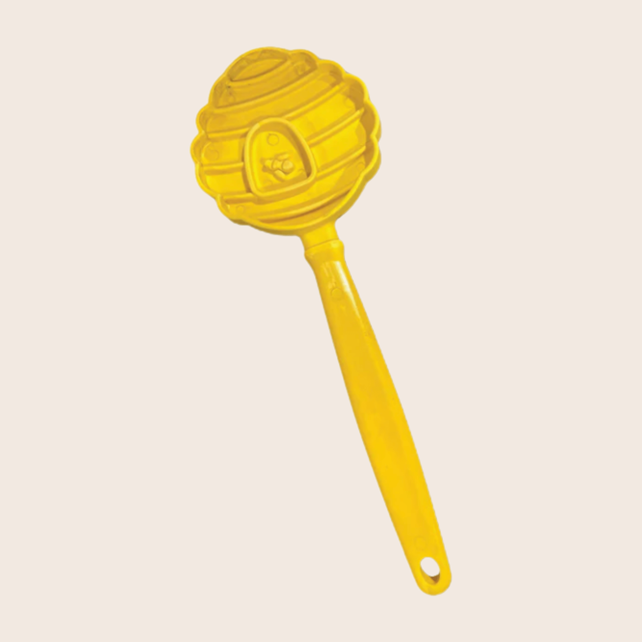 A Farm to Pet Lick Stick Yellow Beehive-shaped  on a beige background.