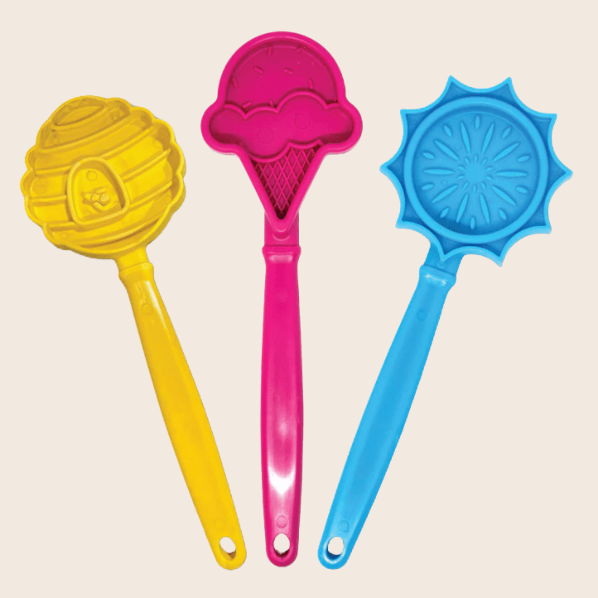 Three colorful Farm to Pet Lick Sticks yellow beehive, pink ice cream  and blue flower on a beige background