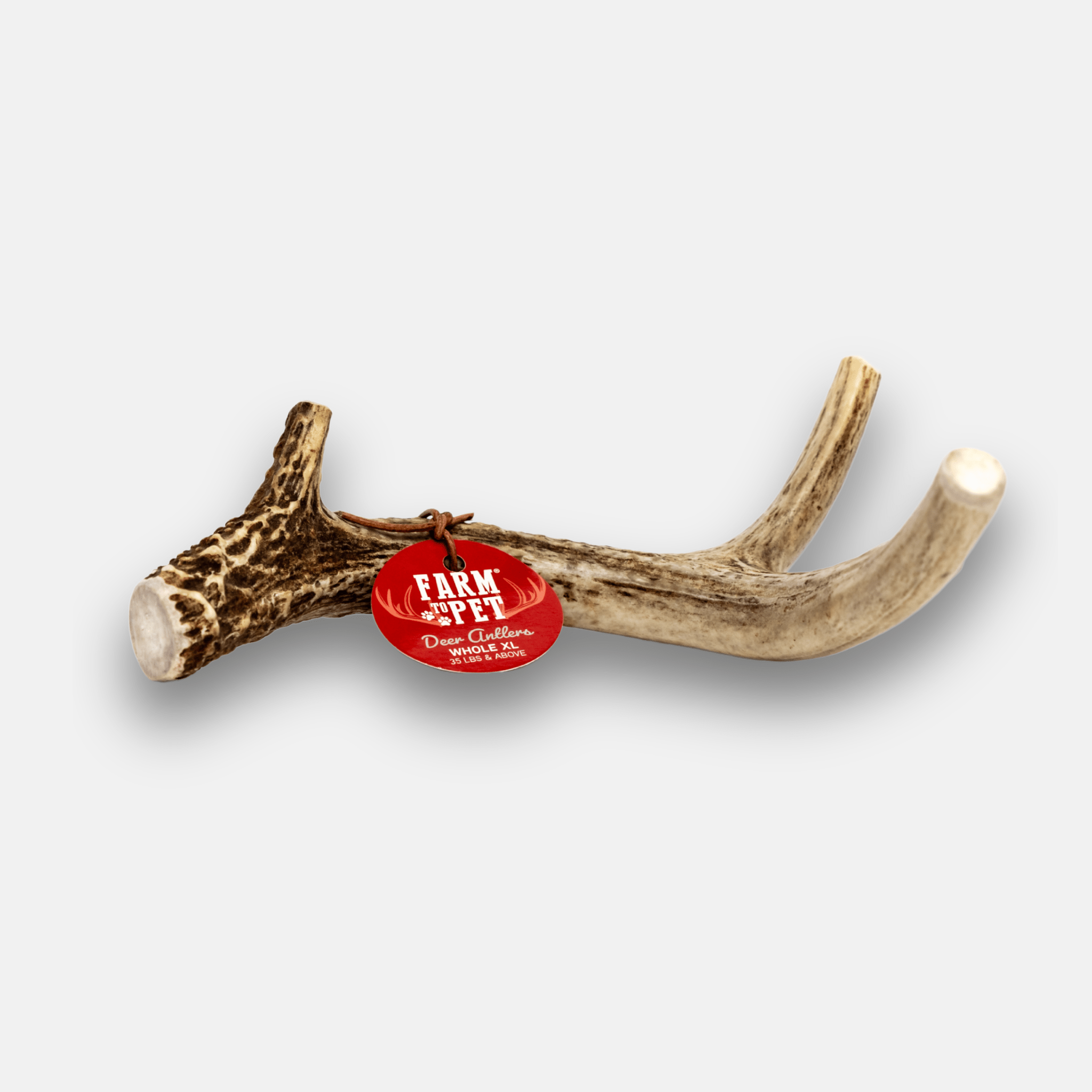 Antler with a red tag labeled 'Farm to Pet' on a white background.