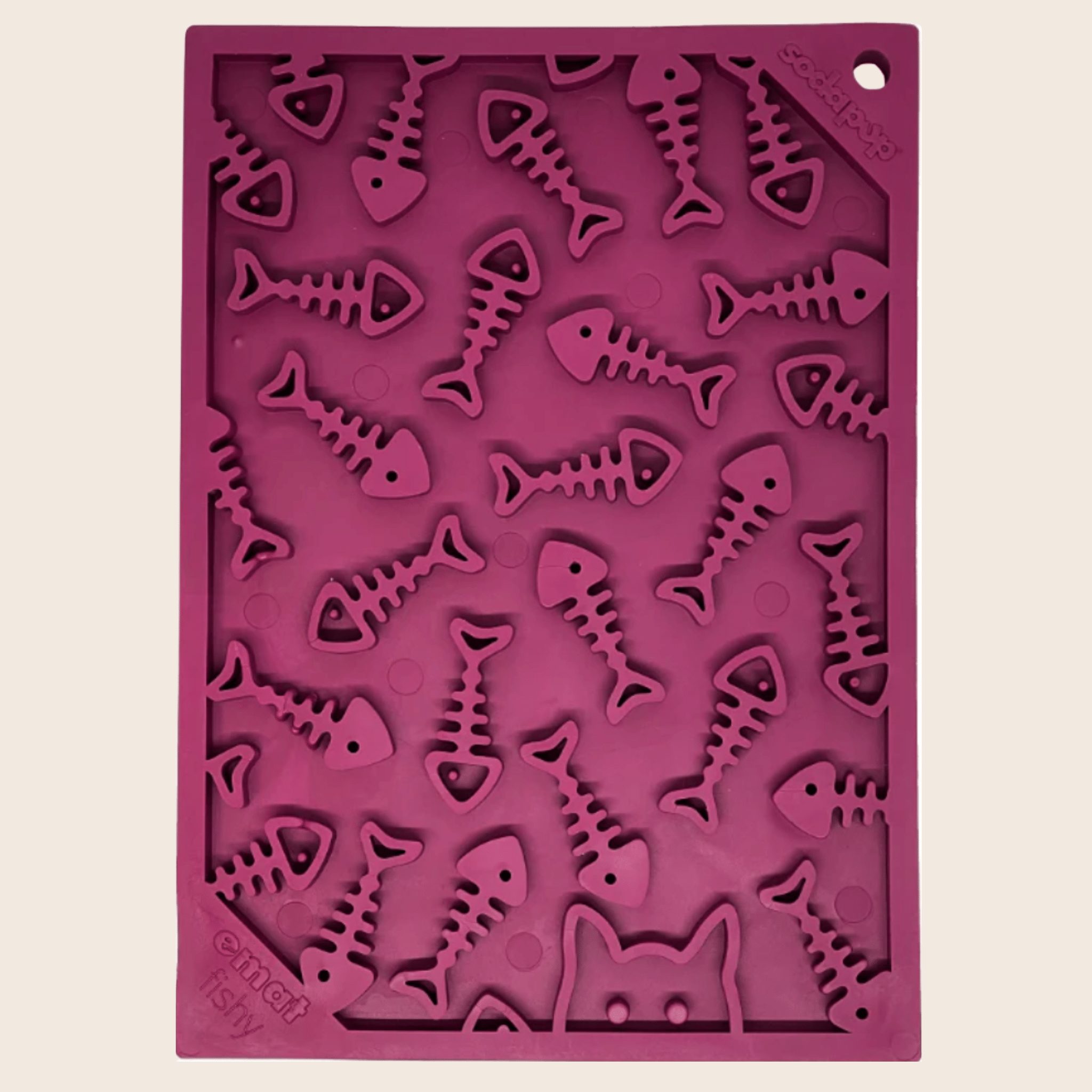 A maroon silicone Farm to Pet Lick Mat with fish skeleton designs on a beige background.