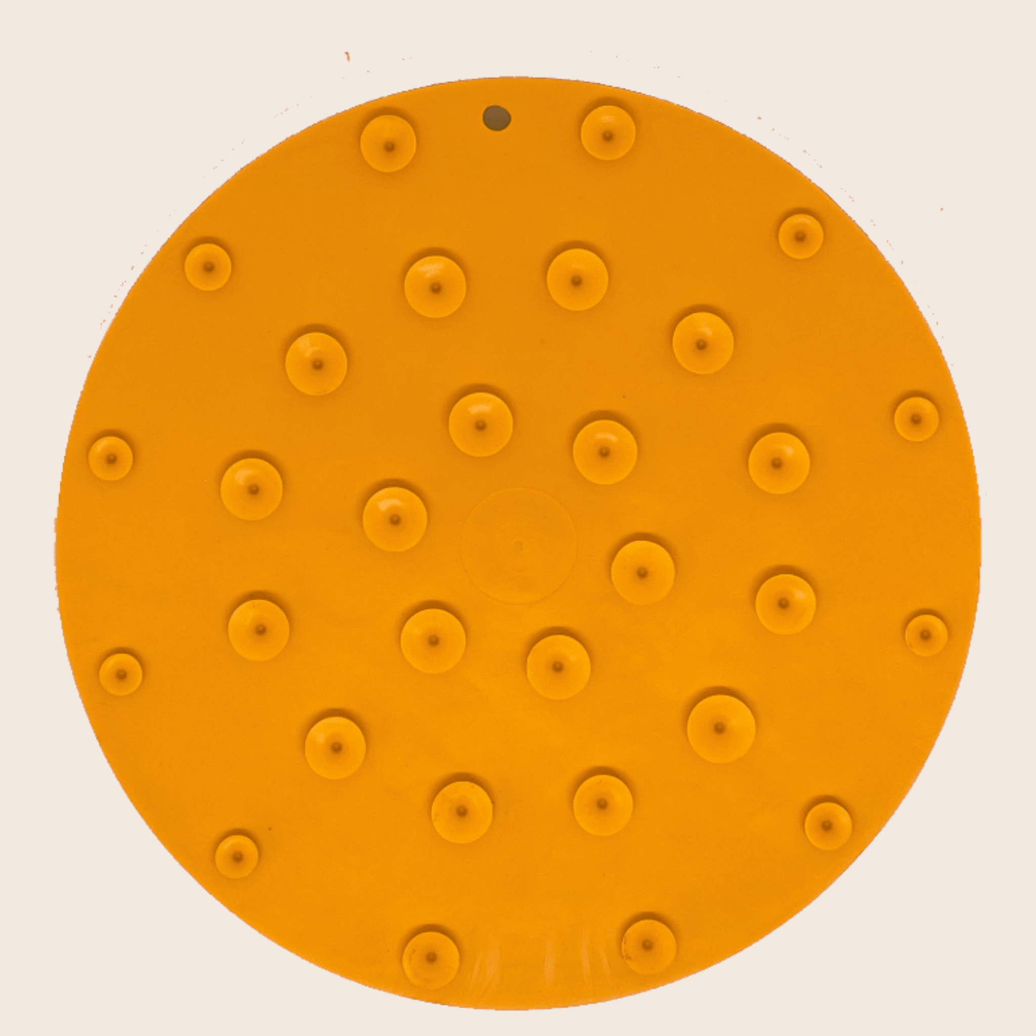 A back view of a Farm to Pet Orange Dog Lick Mat with suction cups on a beige background