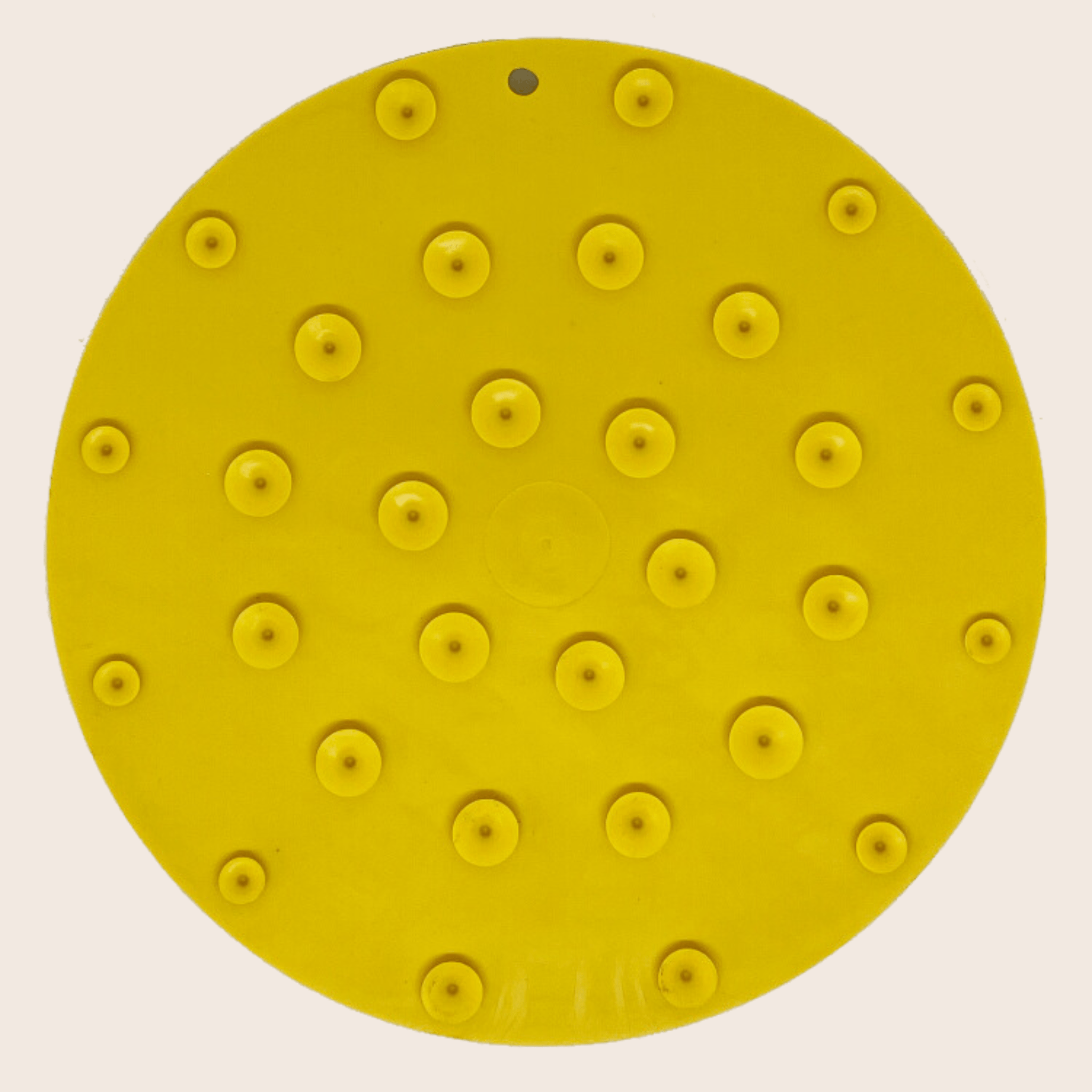 Farm to Pet Yellow round lick mat showing suction cups on back on a beige background.