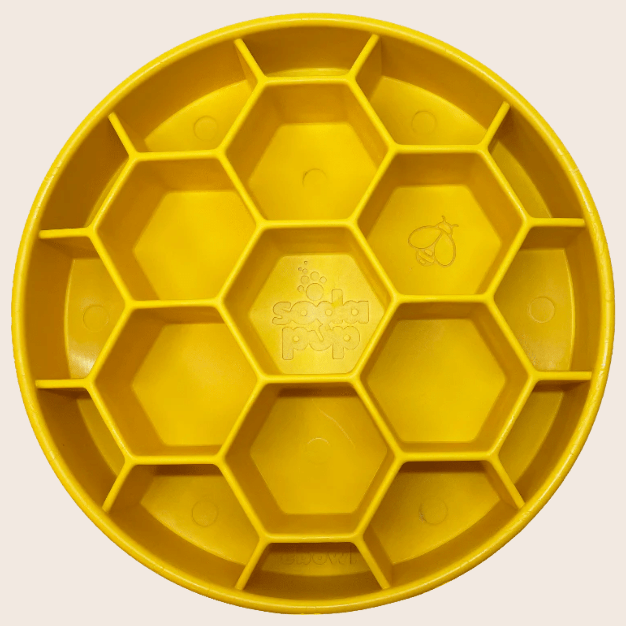 Farm to Pet Yellow honeycomb-shaped slow feeder dog bowl  on a beige background.