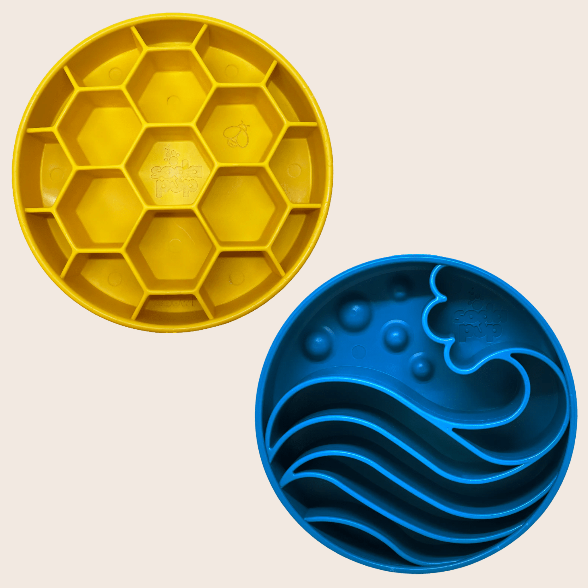 Two Farm to Pet Slow Feeder Dog Bowls Yellow honeycomb-patterned  and blue wave pattern on a beige background.