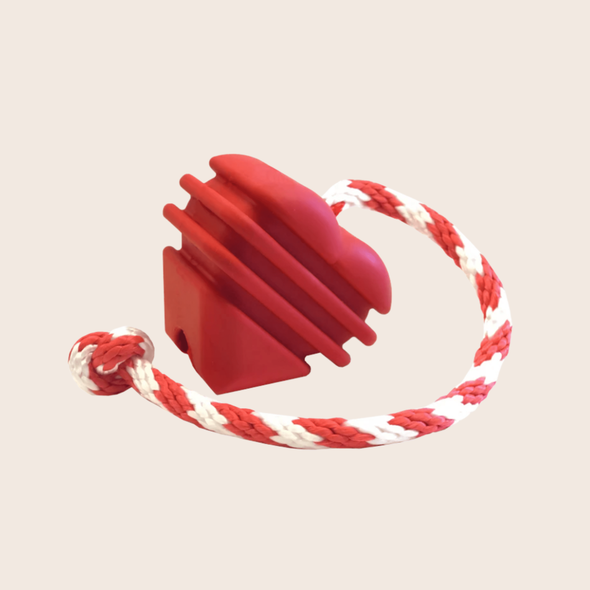 Farm to Pet Tug Toy a Red Heart on a String dog tug with a red and white rope on a beige background.