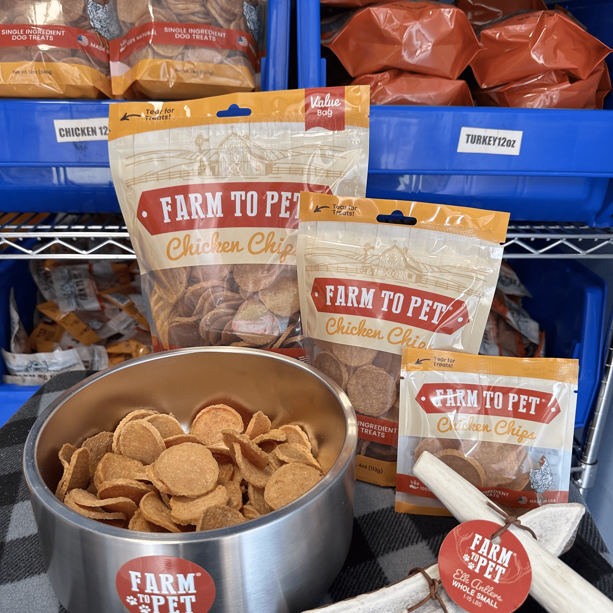 Product picture of Farm to Pet Whole Small Elk Antlers 12 oz. and 4oz  bags of Chicken Chips with a metal dog bowl full of chicken chips.