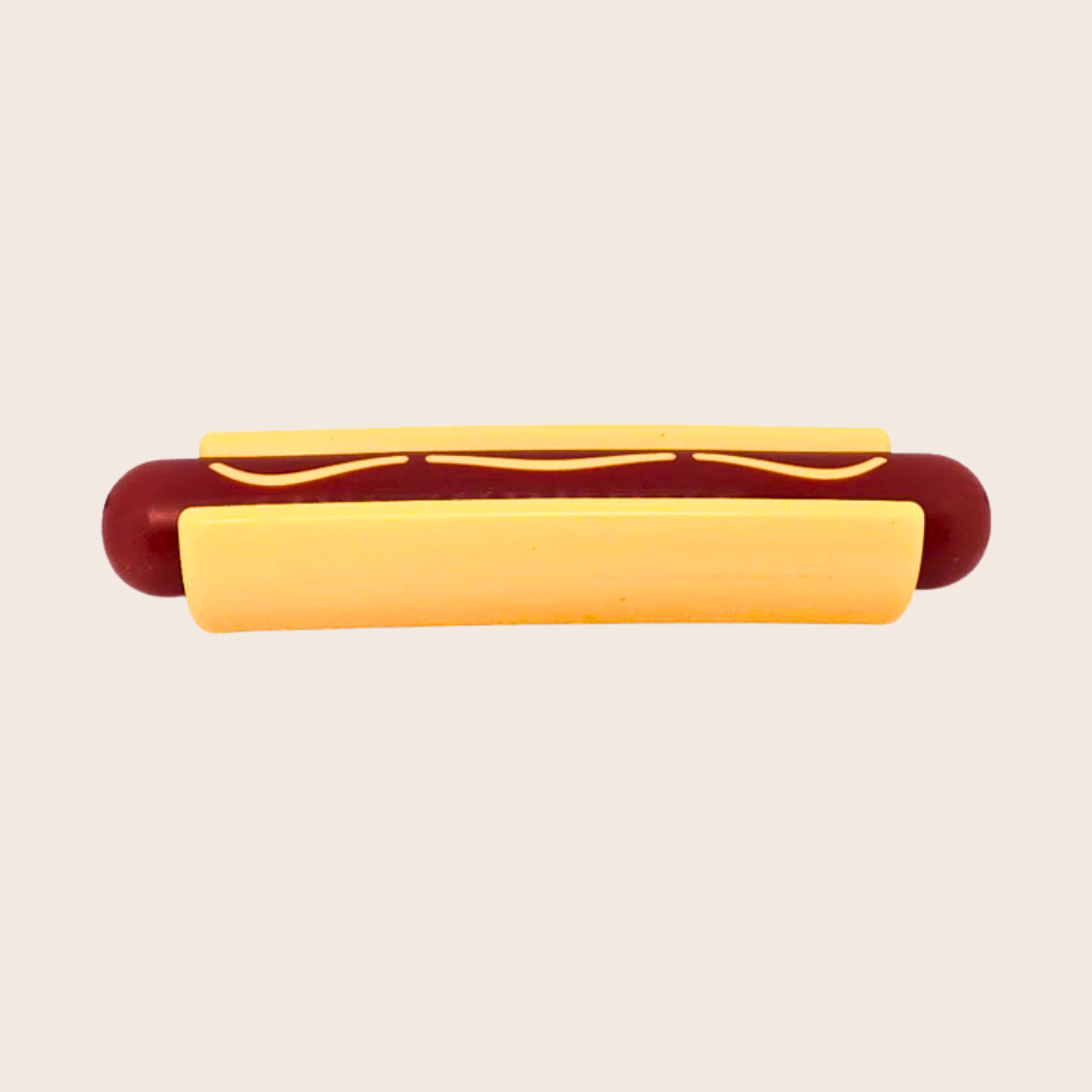 Hot dog with a bun chew toy on a beige background