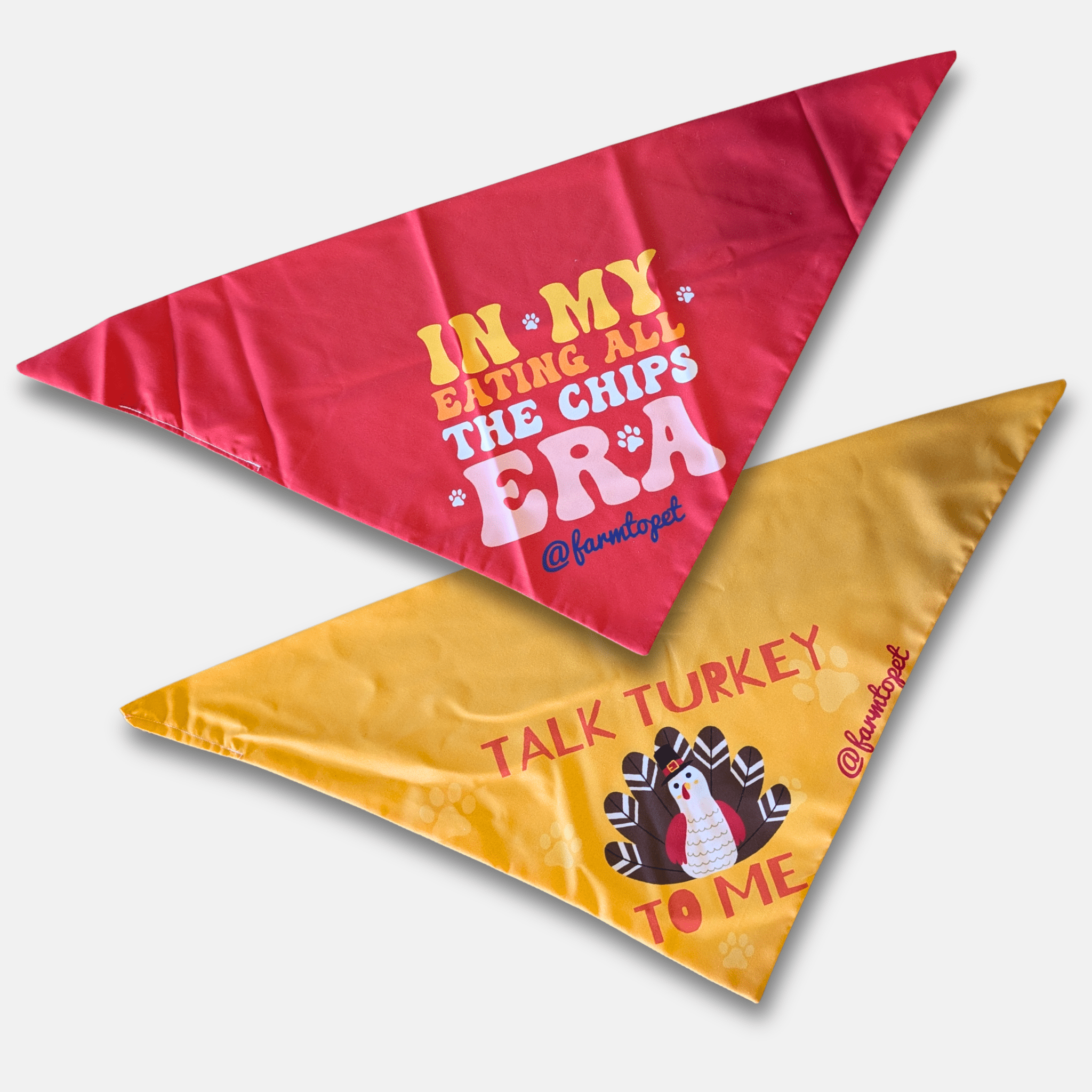 Two triangular bandanas with humorous text and graphics on a white background