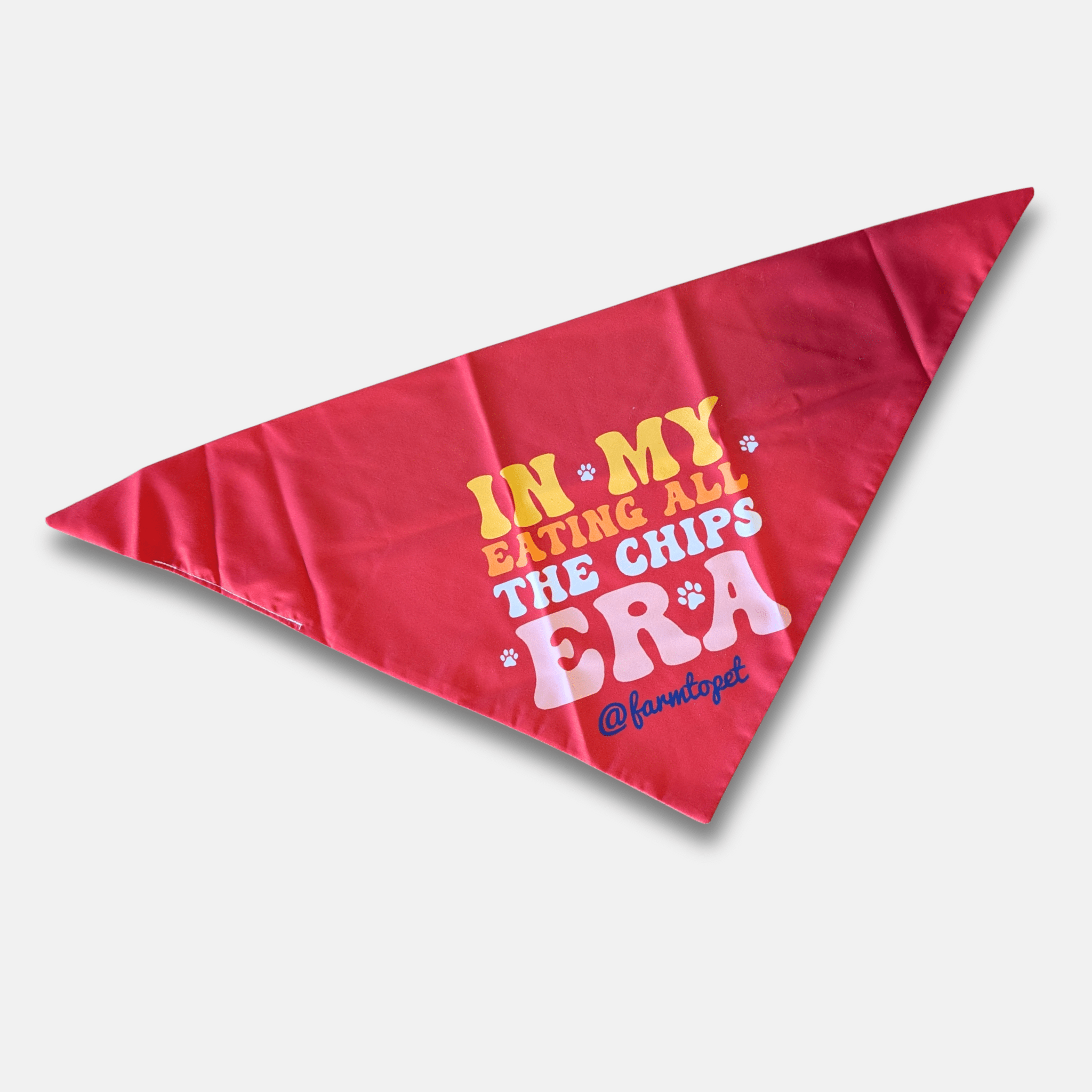Red triangle-shaped dog bandana with humorous text on a light gray background from Farm to Pet that has a Taylor Swift theme.