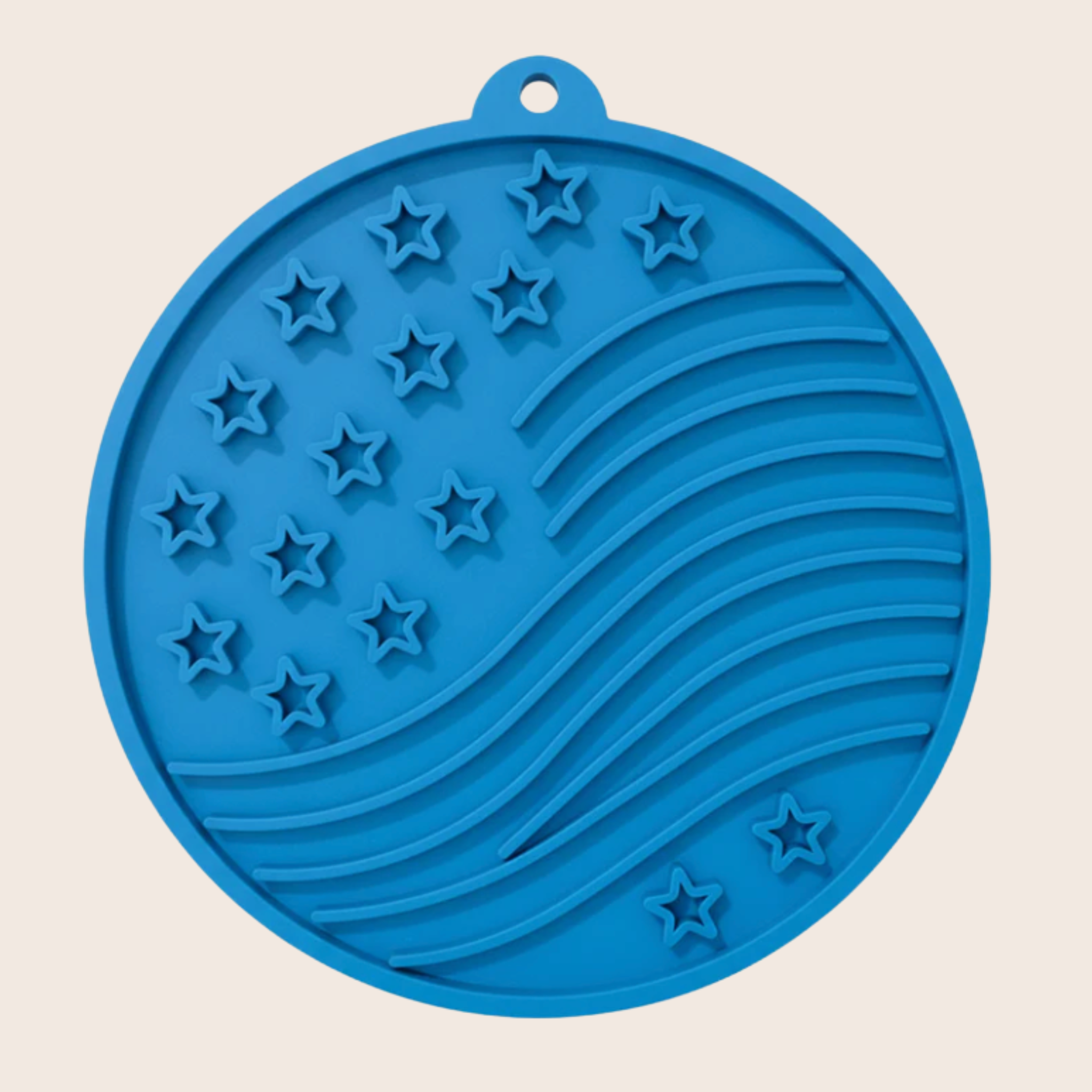 Blue lick mat mat with star and stripe pattern on a beige background
