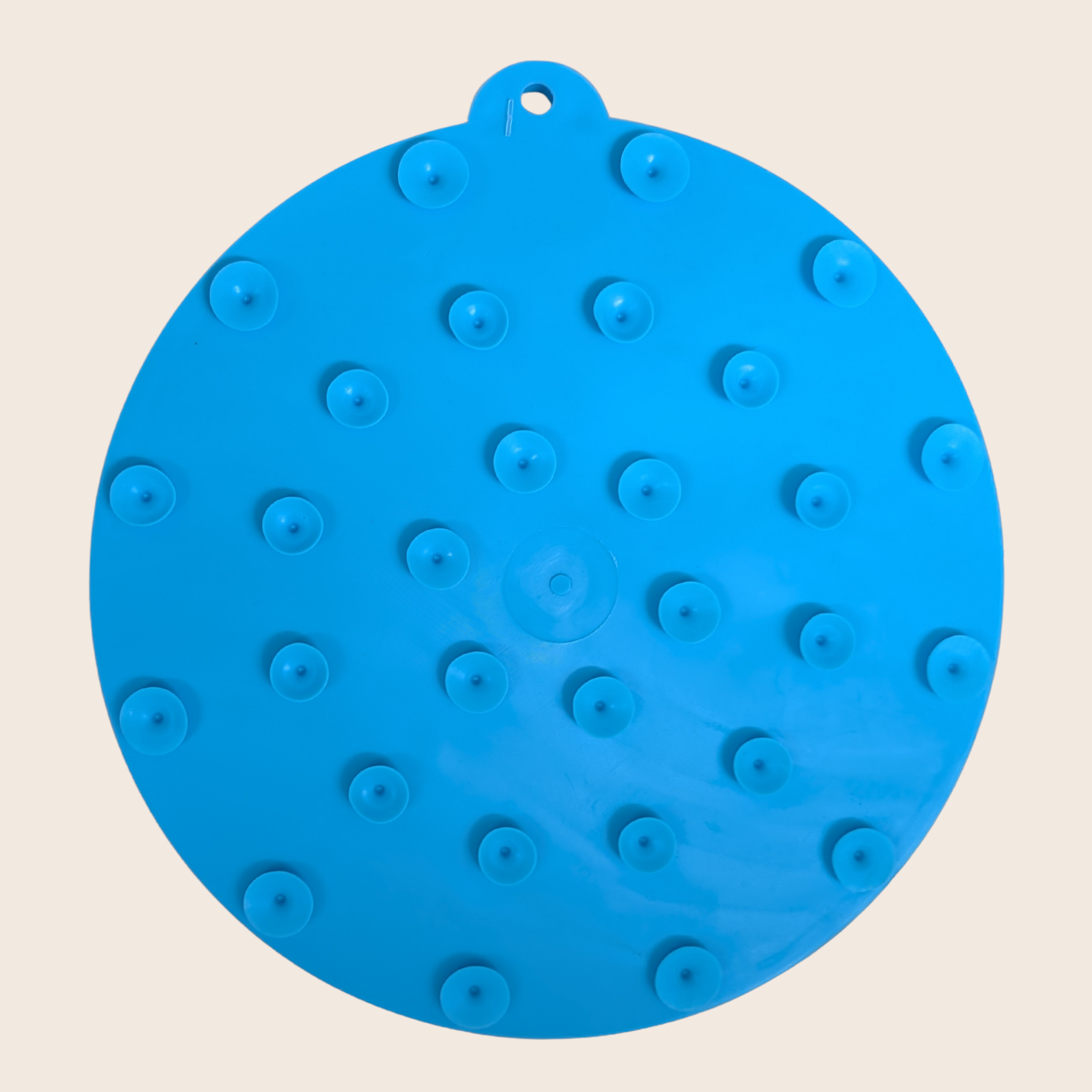 back side of blue circular lick mat with suction cups