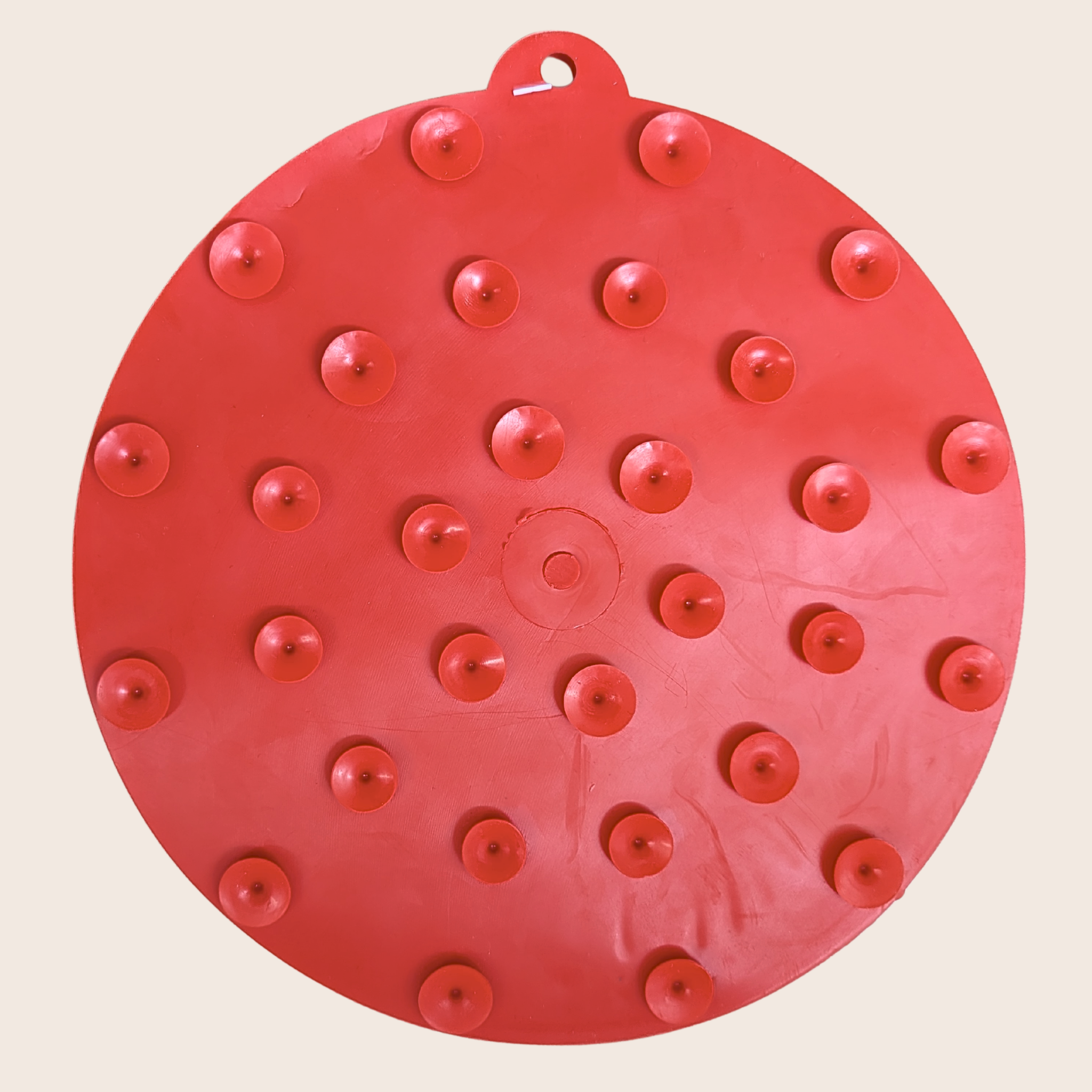 back side of red circular lick mat with suction cups