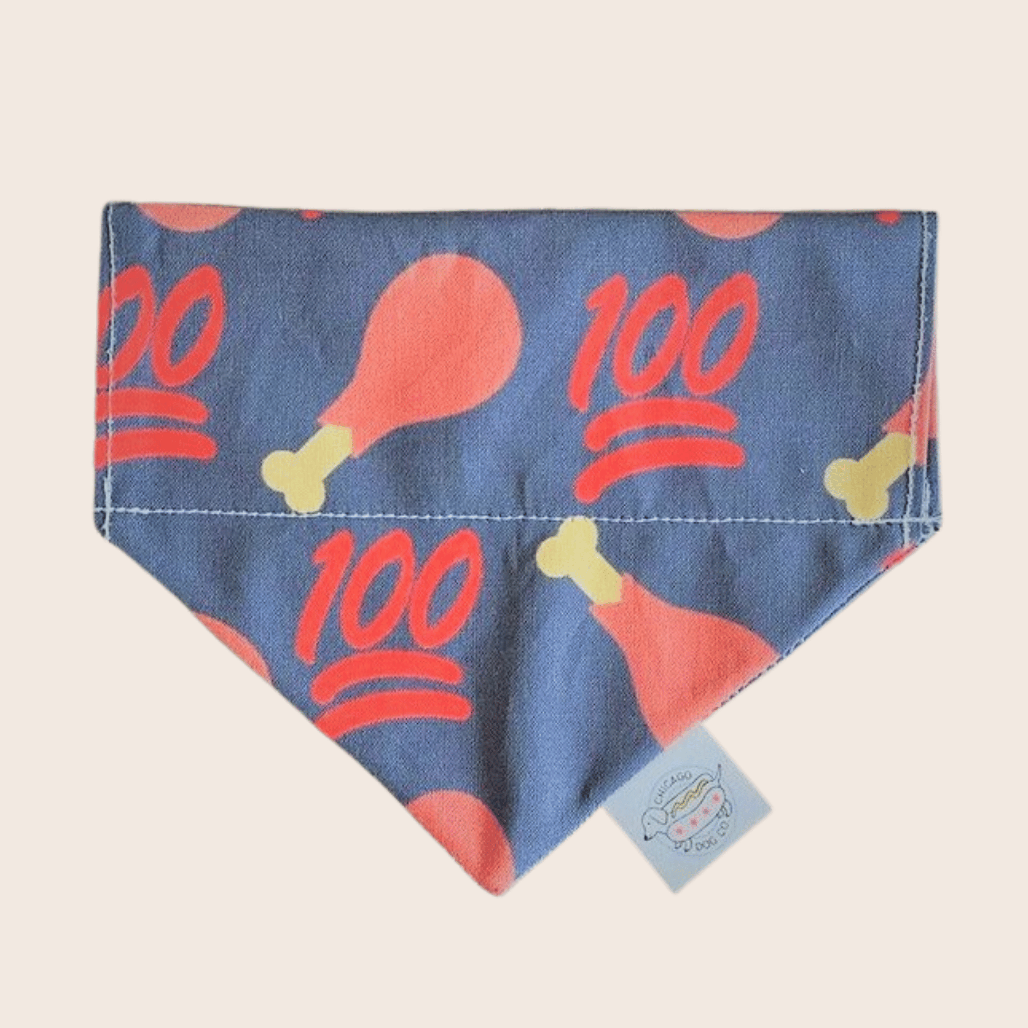 Farm to Pet Dog bandana with chicken drumsticks and 100% pattern on a grey background.