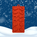 Red silicone mold with Christmas shapes on a snowy background