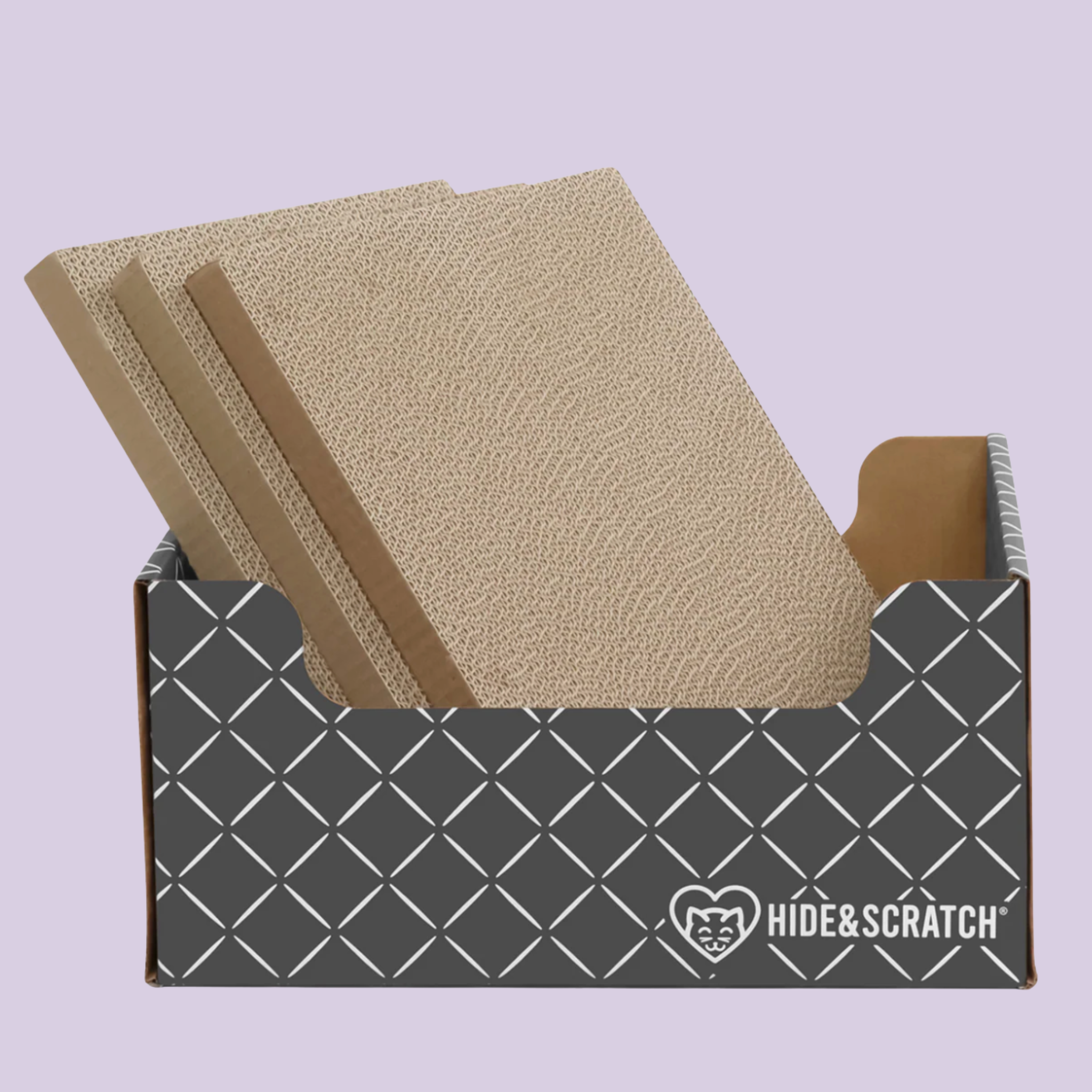 Hide & Scratch cat scratcher box with refill scratcher pads inside on a purple background