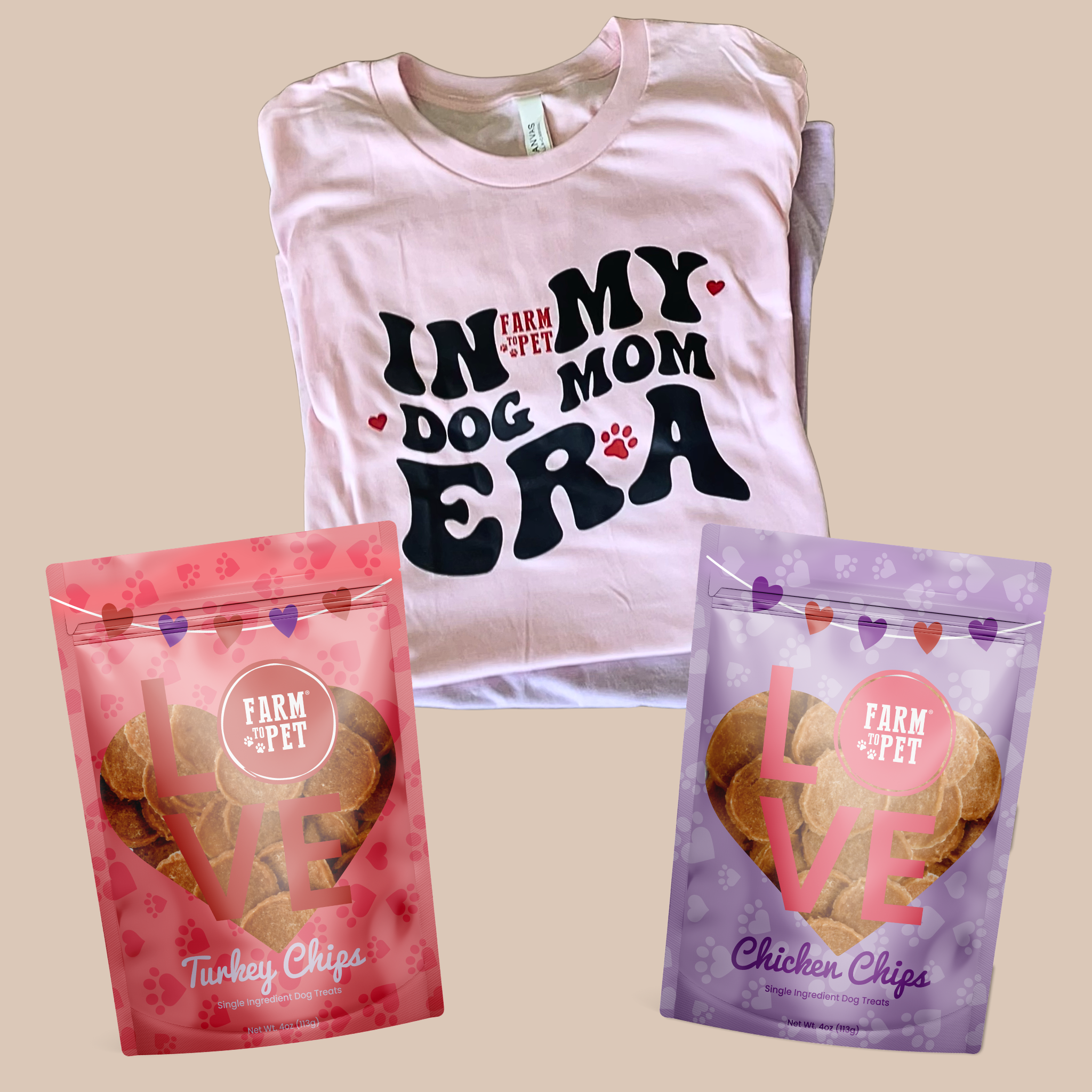 Pink t-shirt with 'In My Mom Dog Era' text and two bags of dog treats on a beige background