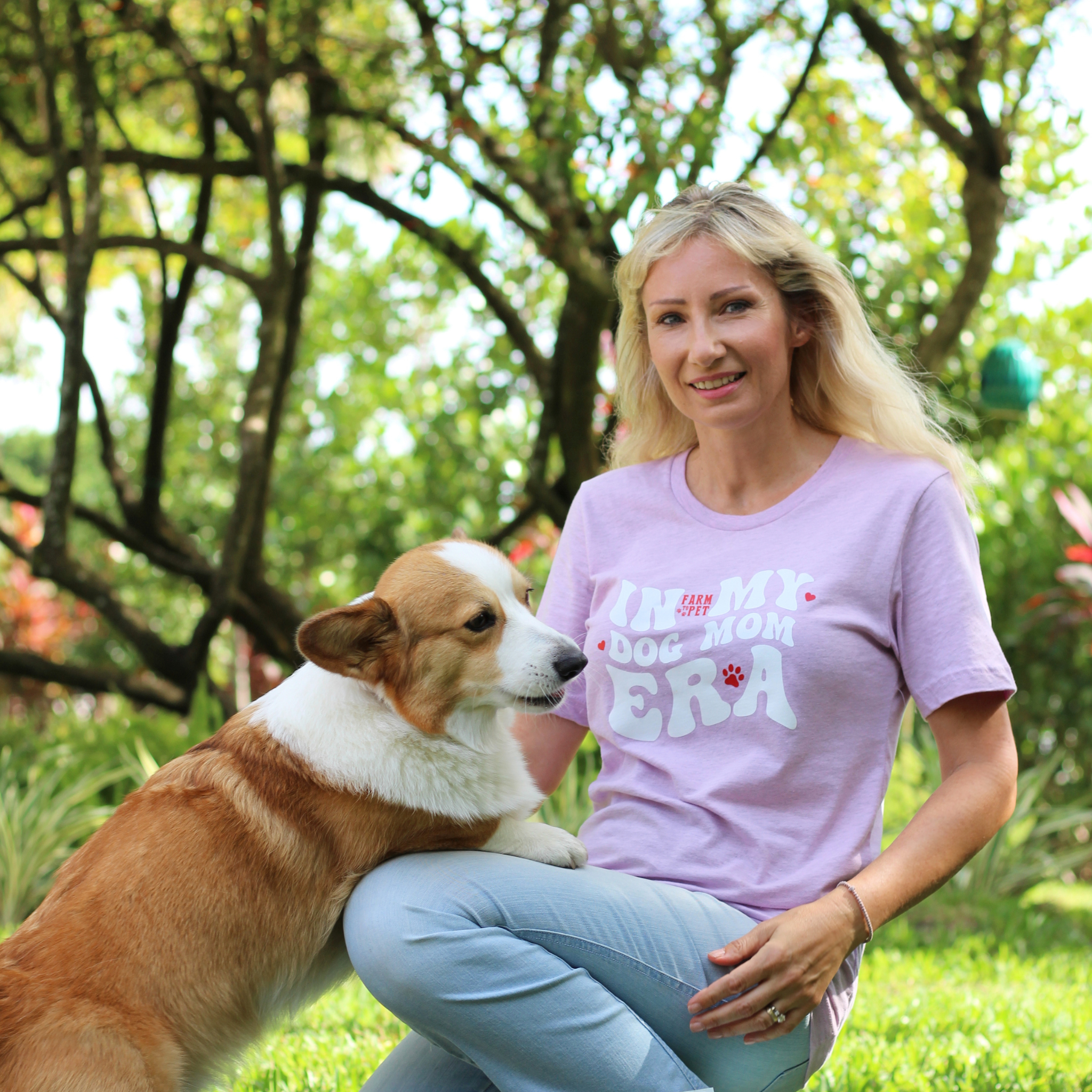 Woman in a purple t-shirt with a dog outdoors