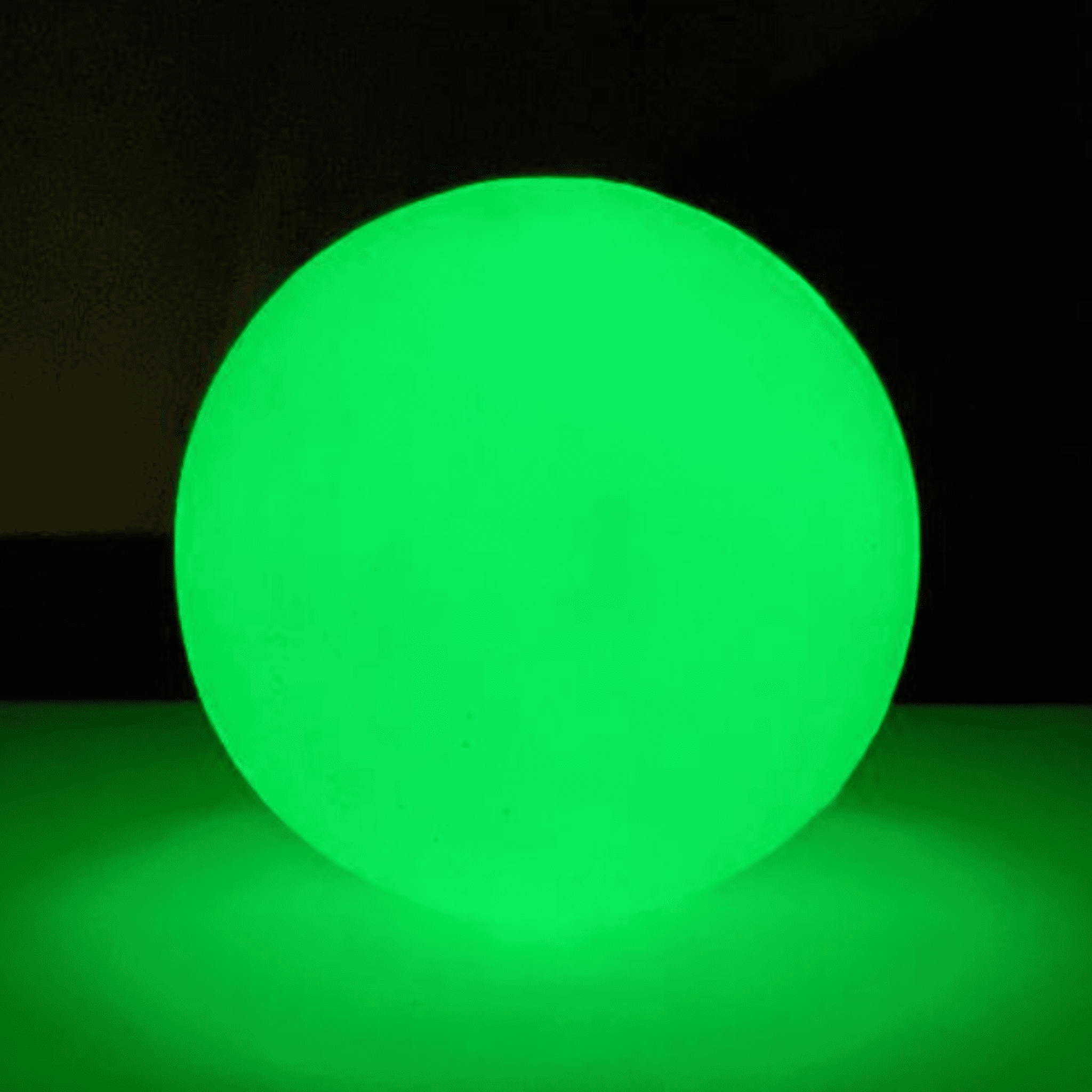 Glowing green Farm to Pet treat dispenser shown in the dark