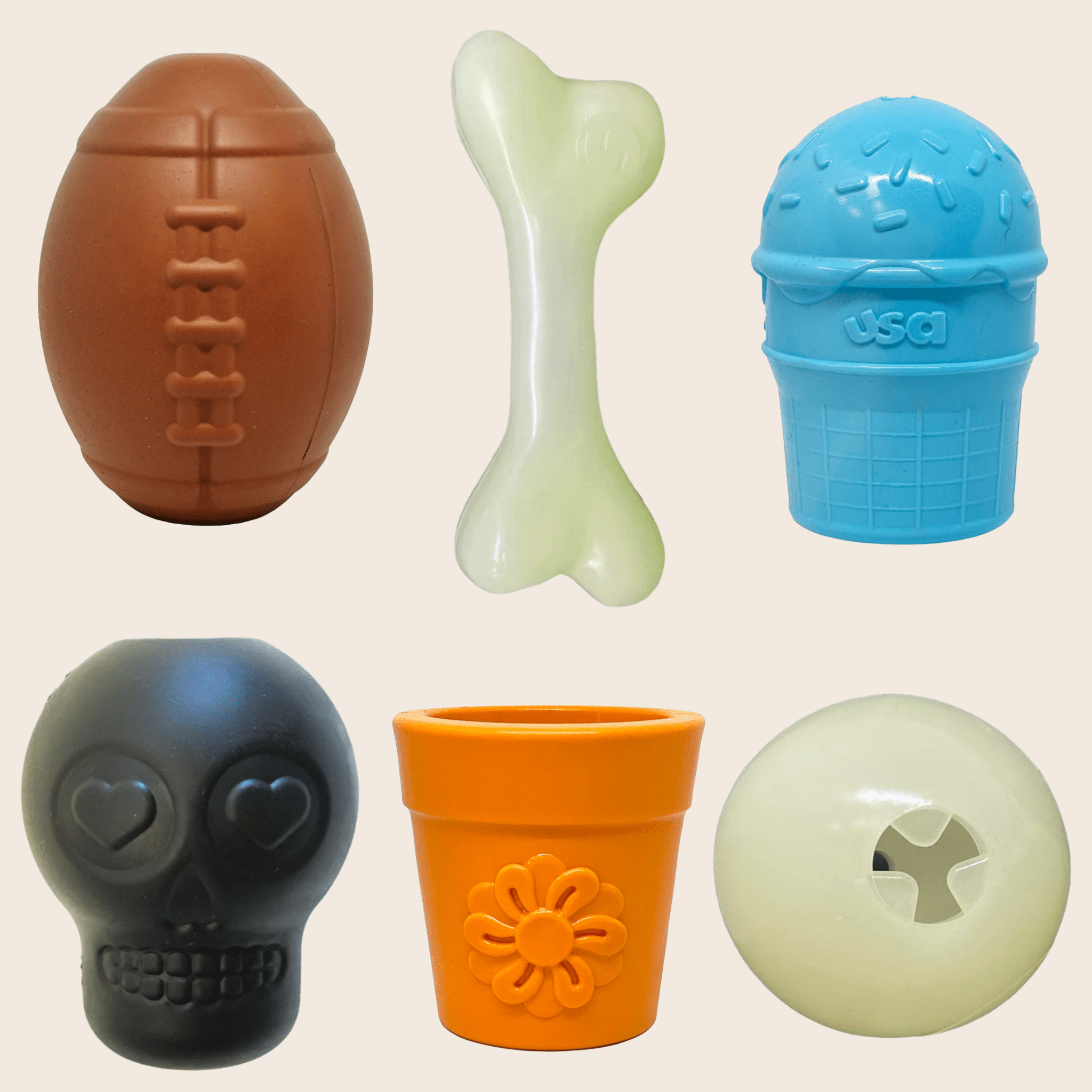 Collection of farm to pet treat dispensers dog toys on a beige background