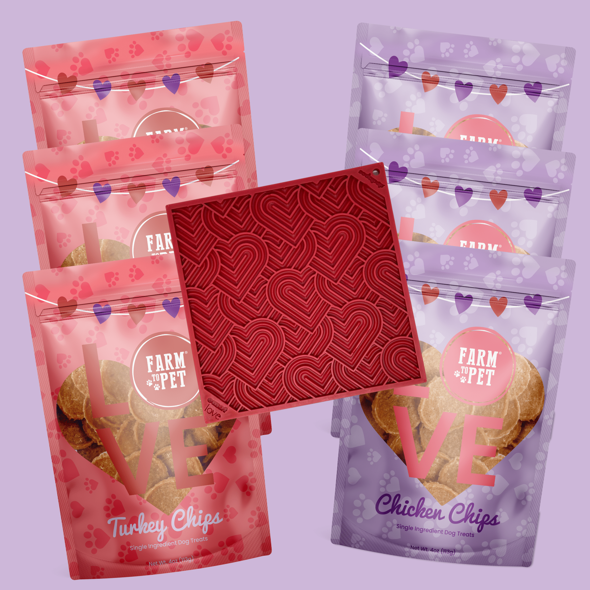 Six packages of Farm to Pet dog treats and lick mat on a purple background